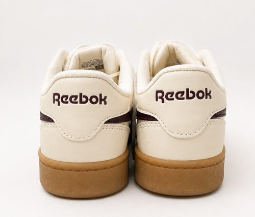 Back view of Reebok women’s white and burgundy sneakers with gum sole, size 6